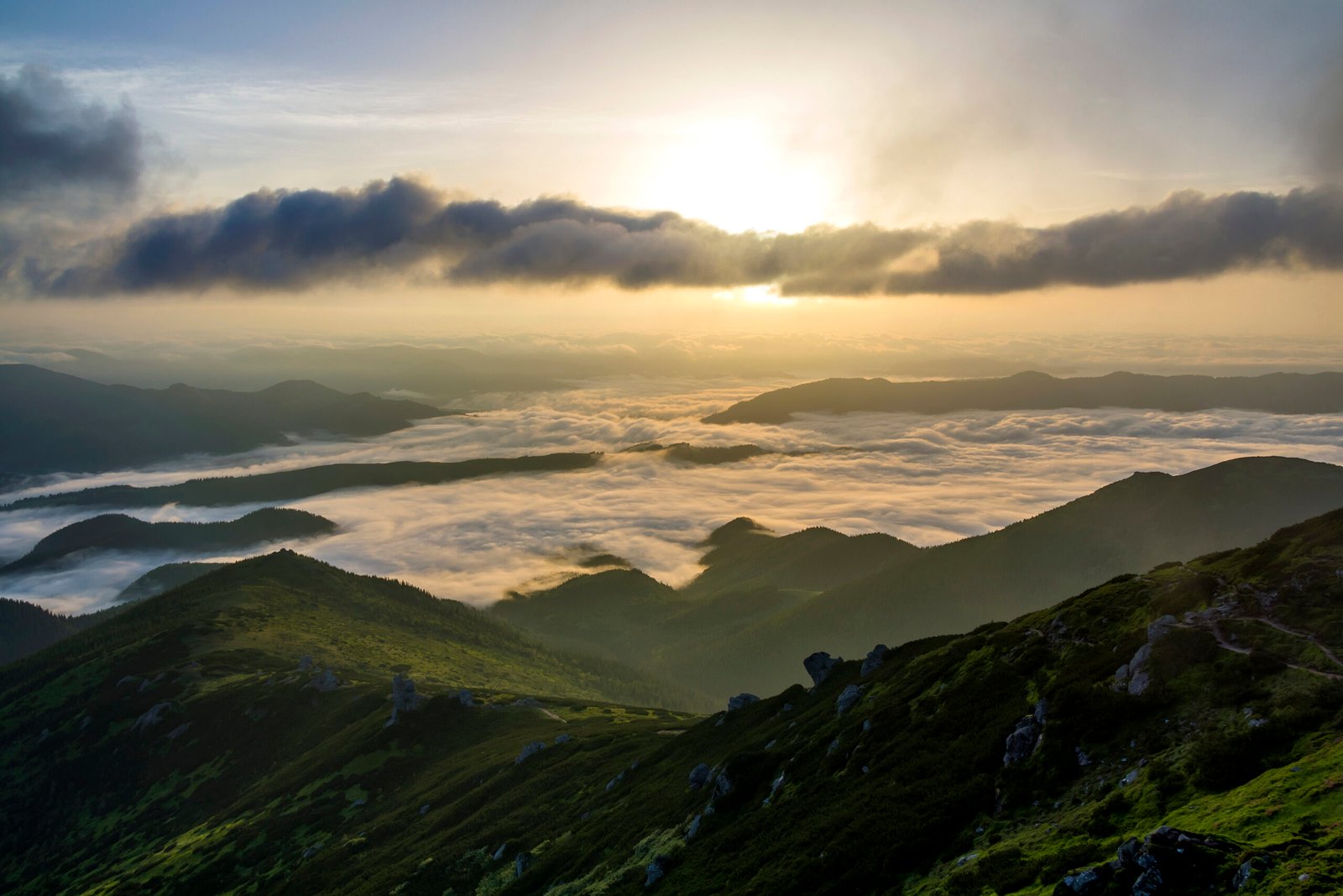 Fantastic view of mountain valley covered with low white puffy l